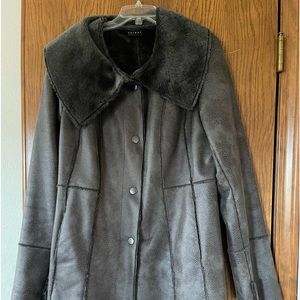 Really cozy faux lamb wool fun and fashionable coat. Comes to mid thigh.